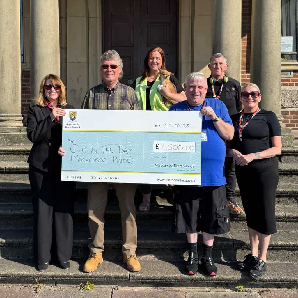Representatives from LGBT Out In The Bay are presented with a cheque for £4,500 in support of Morecambe Pride from Councillors Geoff Knight and Deborah Knight