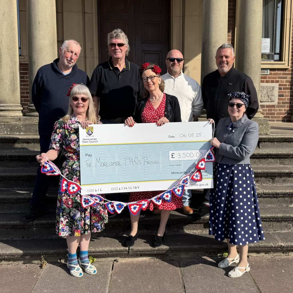 Members of the 1940s Revival committee are presented with a cheque for £3,500 by Morecambe Town Councillors